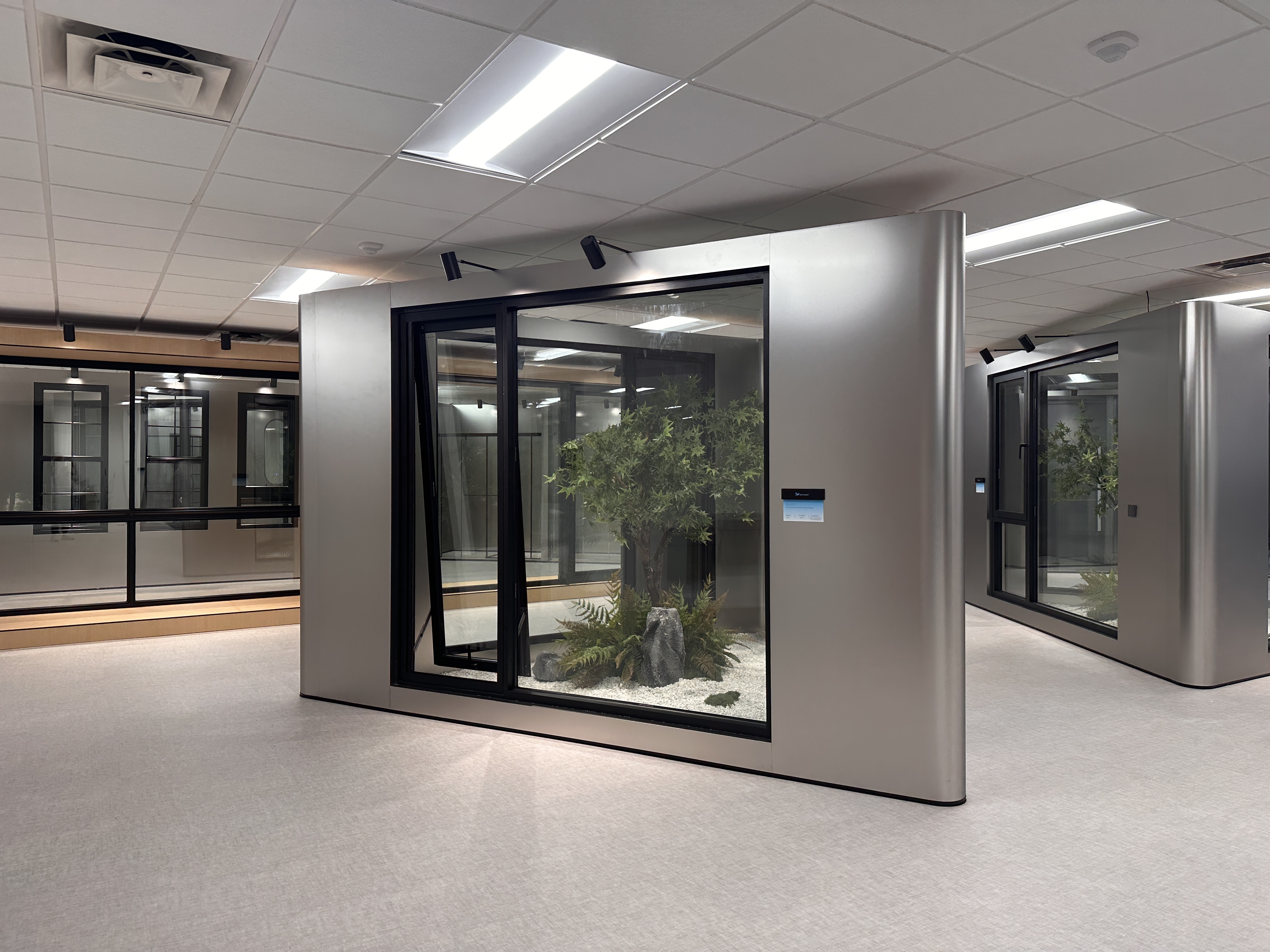 Large framed windows arranged around an indoor display area